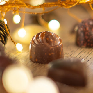 Close-up of chocolate truffles with blurred lights in the background