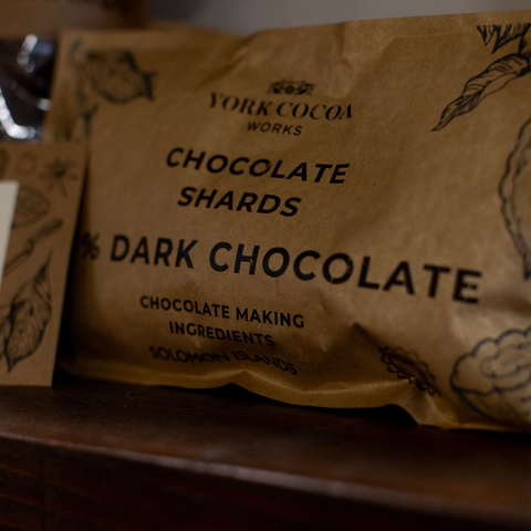 Brown package of York Cocoa Works dark chocolate shards on a wooden shelf