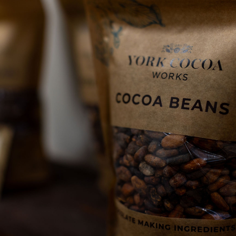 Bag of York Cocoa Works cocoa beans on a shelf with a blurred background