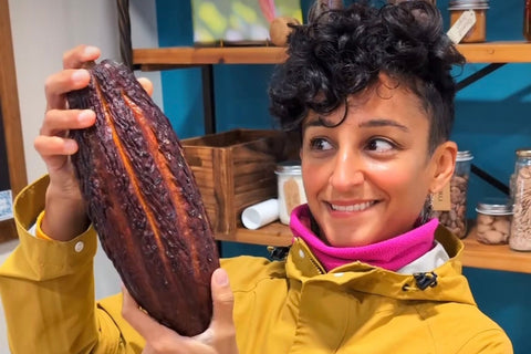 Leyla Kazim holding a large cacao pod at York Cocoa Works