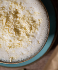 Close up of a white hot chocolate topped with flakes.